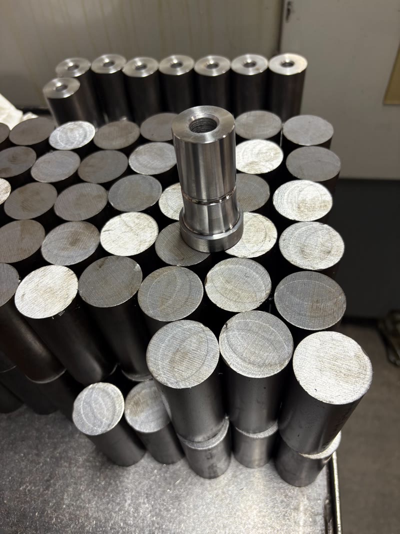 Precision machined part sitting on raw steel stock at RPM Machining Ltd